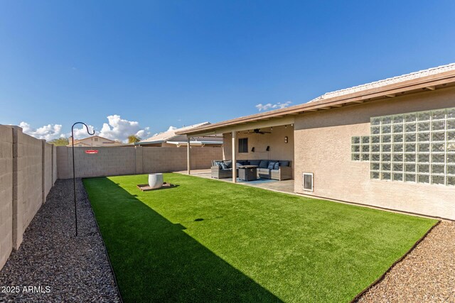 view of yard with ceiling fan, outdoor lounge area, and a patio area