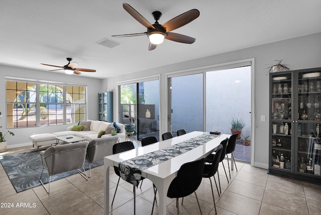 dining area with light tile patterned floors and ceiling fan