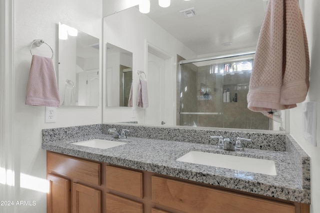 bathroom featuring vanity and an enclosed shower