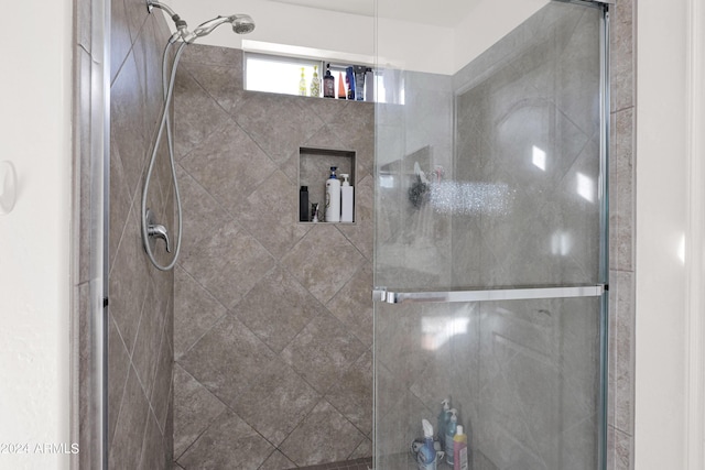 bathroom with a shower with shower door