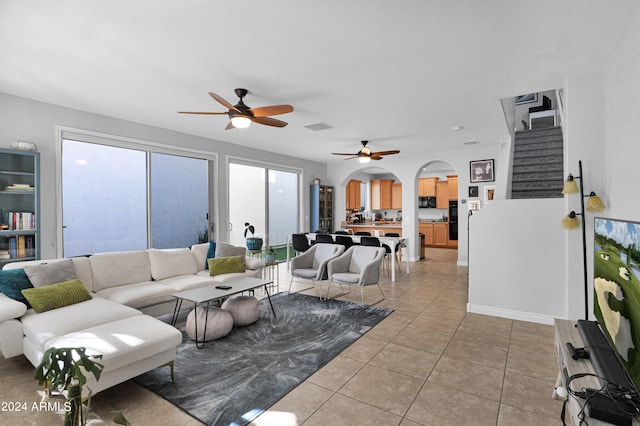 tiled living room featuring ceiling fan