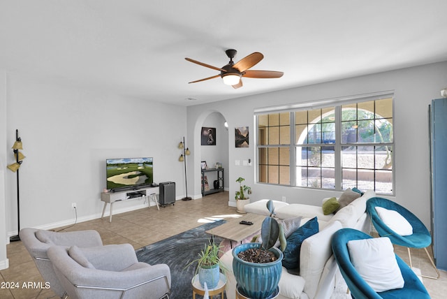 living room featuring light tile patterned floors and ceiling fan