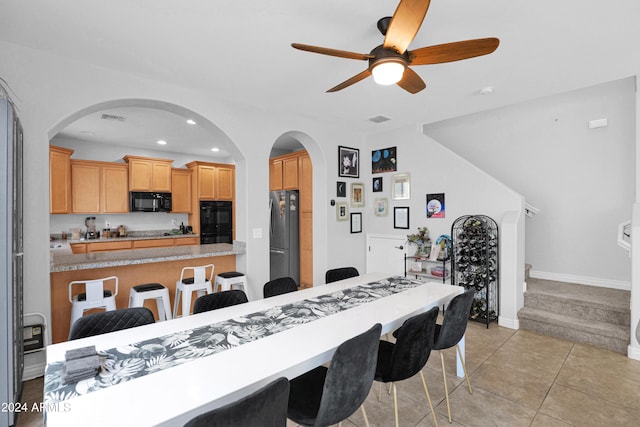 dining room with light tile patterned floors and ceiling fan