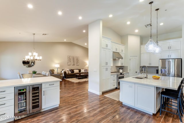 kitchen featuring white cabinetry, sink, wine cooler, a large island, and stainless steel appliances