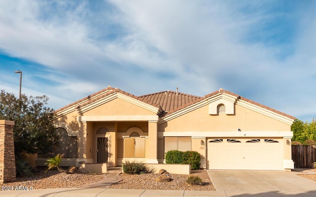 mediterranean / spanish house featuring a garage