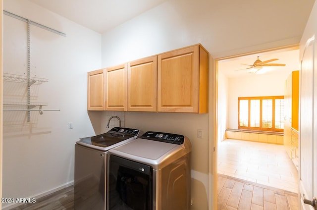 washroom featuring washer and dryer, ceiling fan, and cabinets