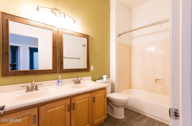 full bathroom with vanity, toilet, wood-type flooring, and tub / shower combination