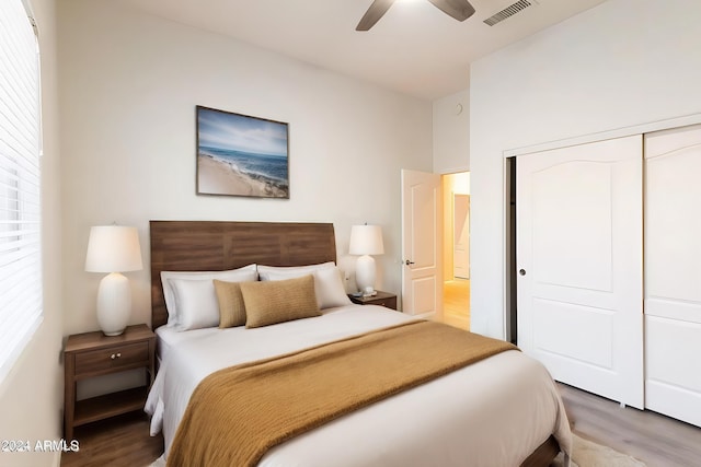 bedroom with hardwood / wood-style flooring, a closet, and ceiling fan