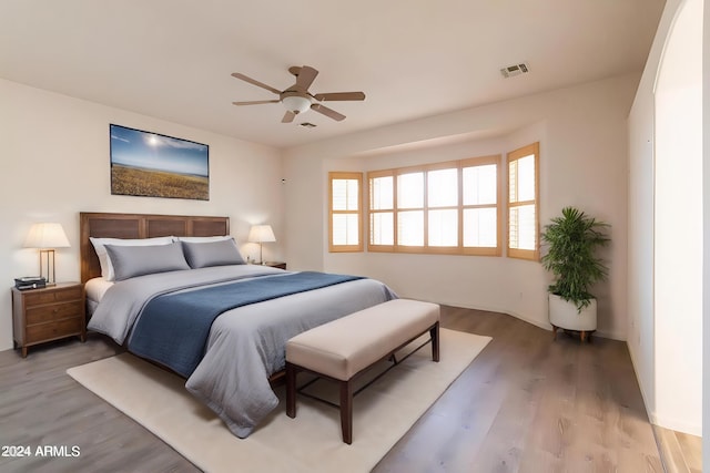 bedroom with hardwood / wood-style floors and ceiling fan