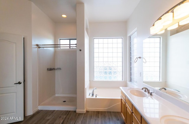 bathroom featuring separate shower and tub, plenty of natural light, vanity, and wood-type flooring