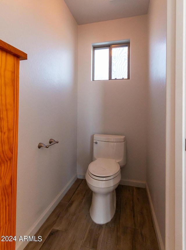 bathroom featuring wood-type flooring and toilet