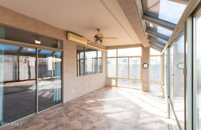 unfurnished sunroom featuring a wall mounted air conditioner, ceiling fan, lofted ceiling, and a wealth of natural light