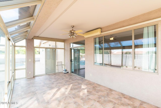 unfurnished sunroom featuring an AC wall unit, ceiling fan, and plenty of natural light