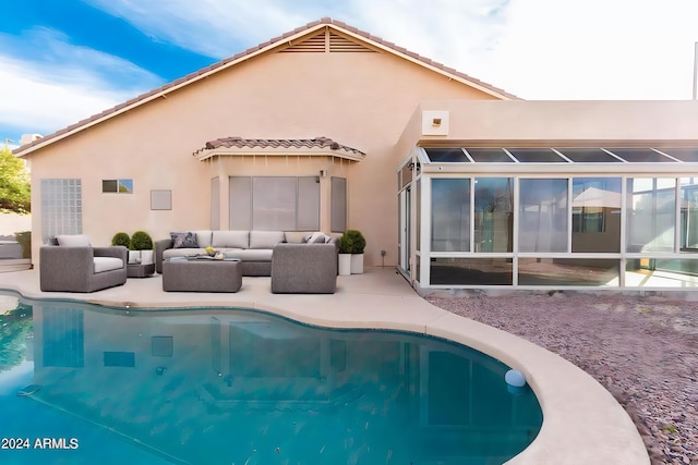 rear view of house with an outdoor living space and a patio area