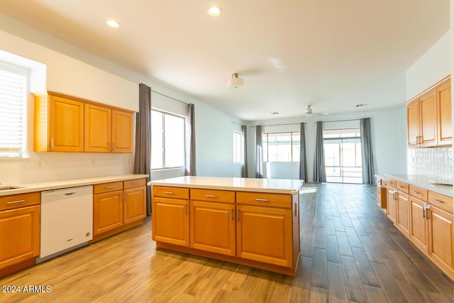 kitchen with decorative backsplash, dishwasher, ceiling fan, and light hardwood / wood-style flooring