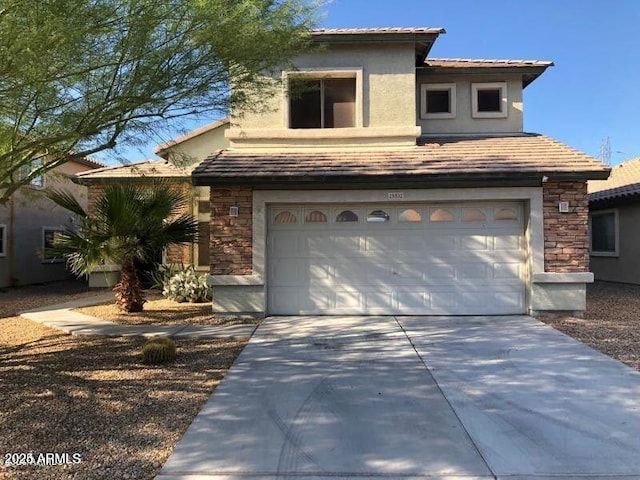 view of front of property featuring a garage, stone siding, concrete driveway, a tiled roof, and stucco siding