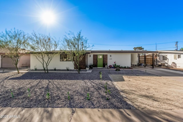 ranch-style house featuring stucco siding