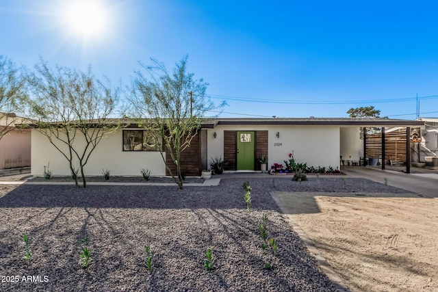 view of front of home featuring an attached carport and stucco siding