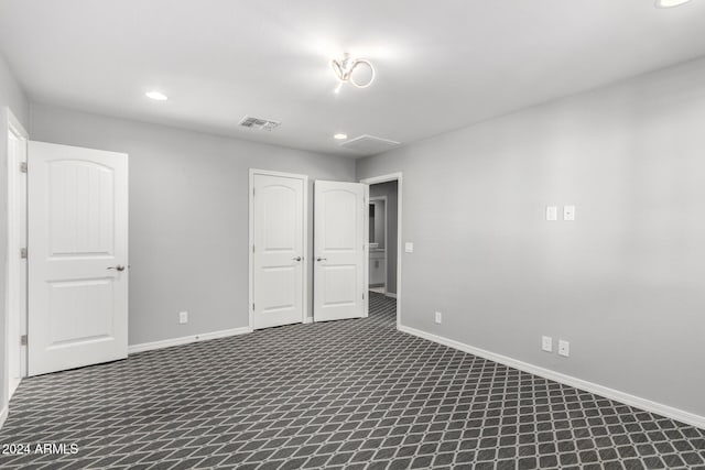 empty room featuring dark colored carpet