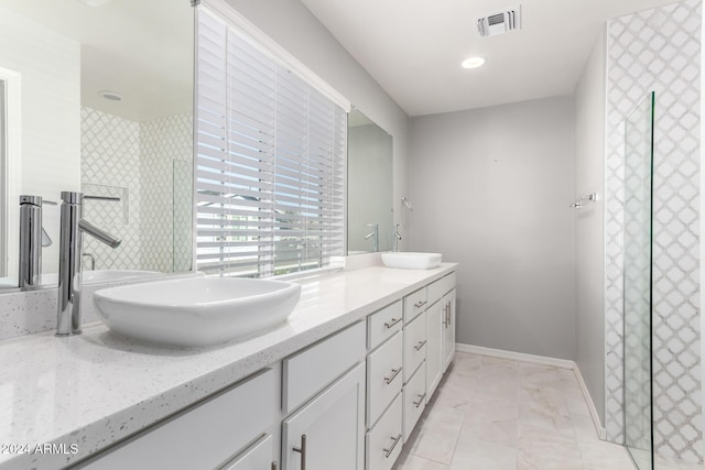 bathroom featuring vanity and tiled shower