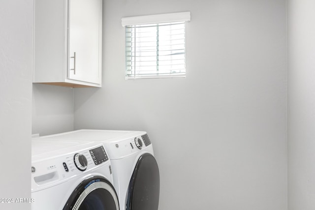 laundry area featuring cabinets and separate washer and dryer