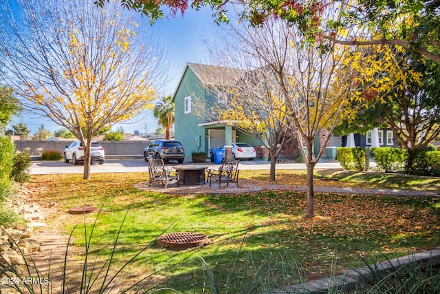 view of yard with a fire pit and central AC unit