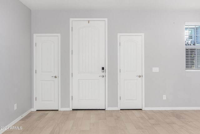 empty room with light hardwood / wood-style floors