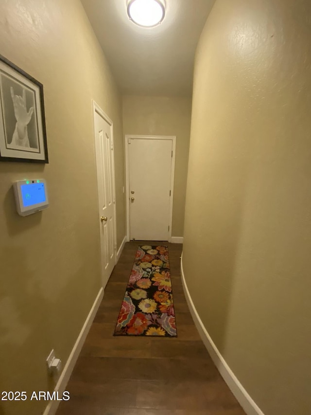 corridor with dark wood-type flooring