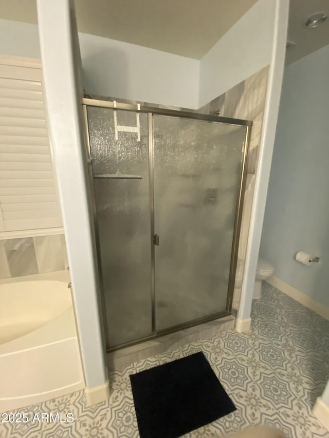 bathroom featuring independent shower and bath, tile patterned floors, and toilet