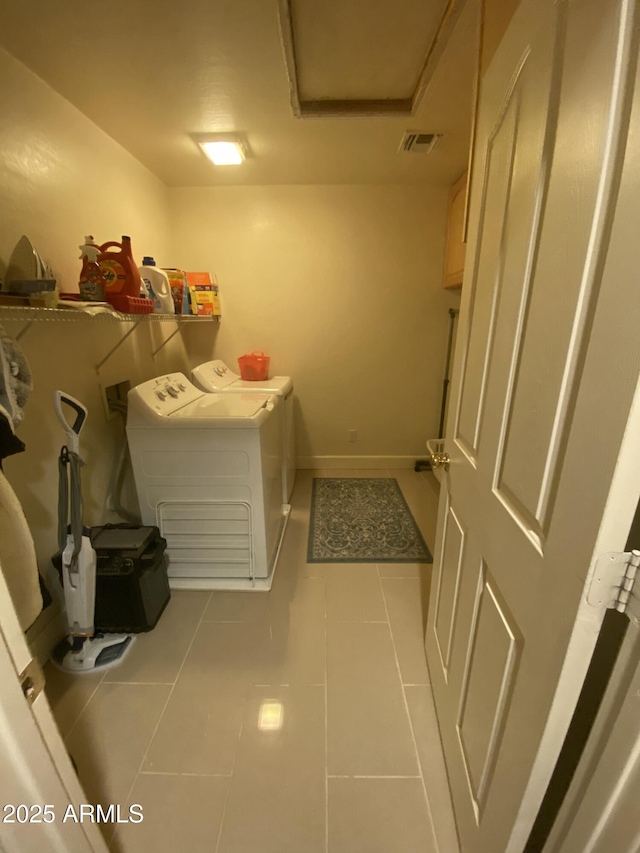 laundry room with separate washer and dryer and light tile patterned floors