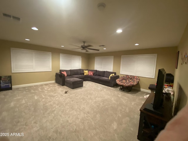 carpeted living room with ceiling fan