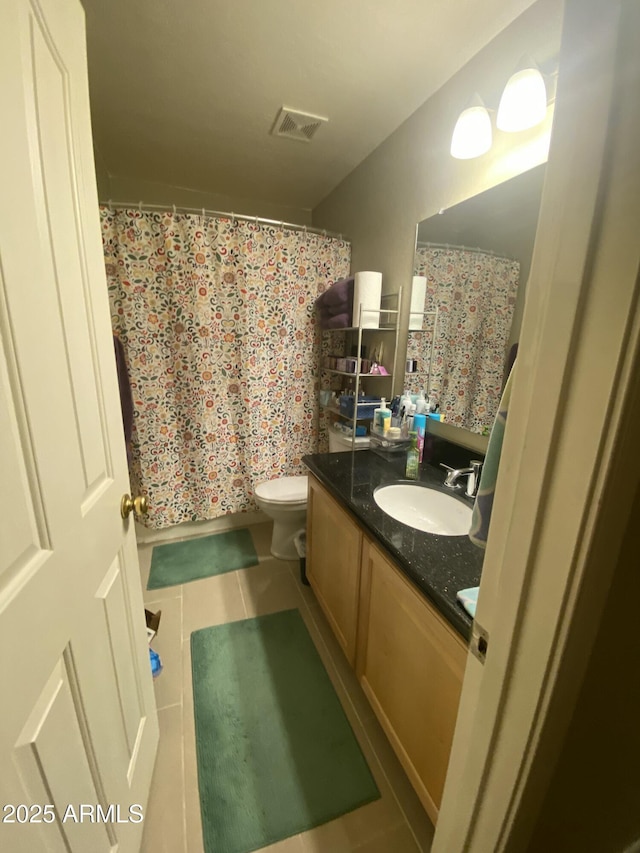 bathroom with vanity, a shower with shower curtain, tile patterned floors, and toilet