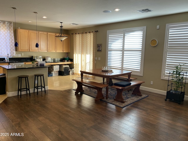 dining area with dark hardwood / wood-style flooring and sink