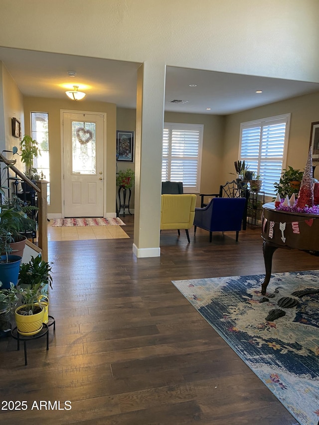 entrance foyer with a healthy amount of sunlight and dark hardwood / wood-style flooring