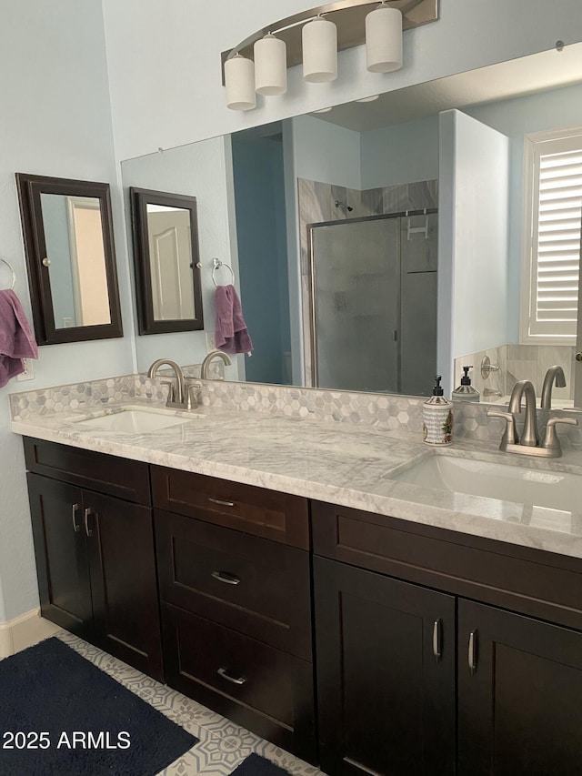 bathroom featuring an enclosed shower and vanity