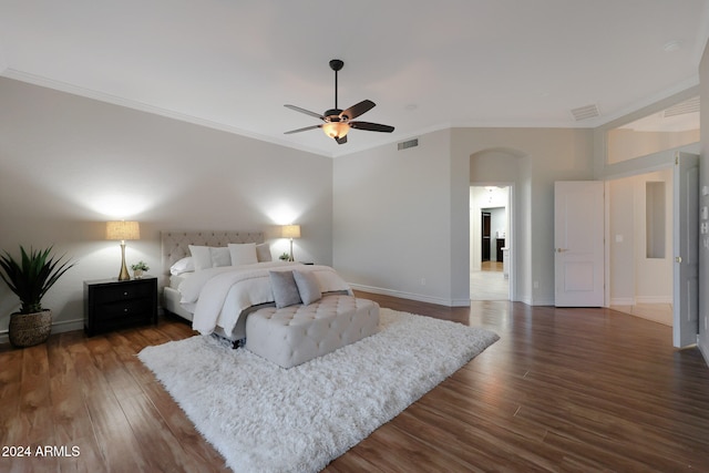 bedroom with crown molding, dark hardwood / wood-style floors, and ceiling fan