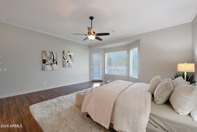 bedroom featuring ceiling fan, crown molding, and dark hardwood / wood-style floors