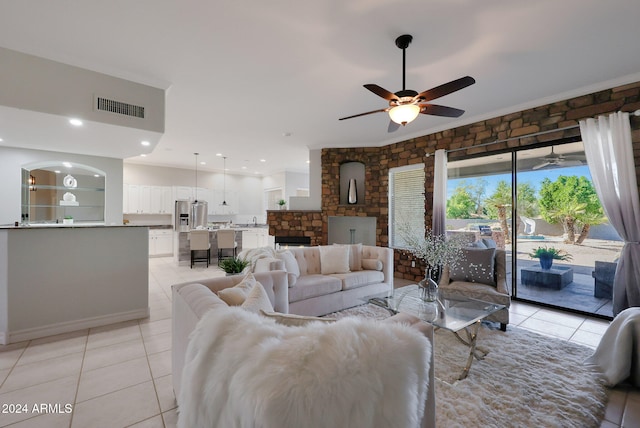 tiled living room with ceiling fan