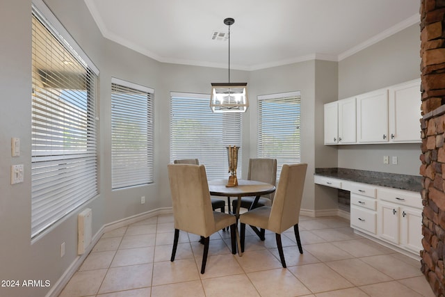 dining room featuring crown molding, built in desk, a notable chandelier, and light tile patterned floors