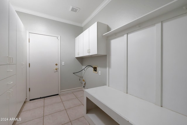 washroom featuring hookup for a washing machine, crown molding, cabinets, and light tile patterned flooring