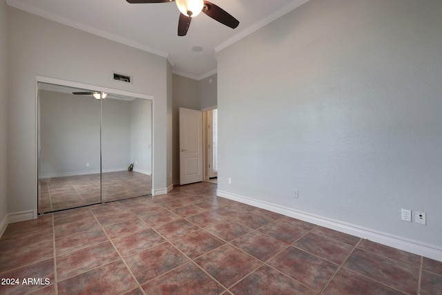 unfurnished bedroom featuring ornamental molding, tile patterned floors, a closet, and ceiling fan