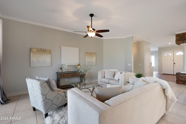 living room featuring crown molding, ceiling fan, ornate columns, and light tile patterned floors