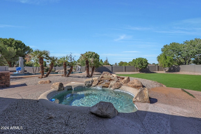 view of pool featuring a lawn