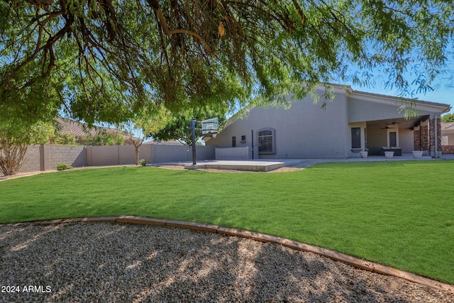 view of yard featuring a patio and ceiling fan