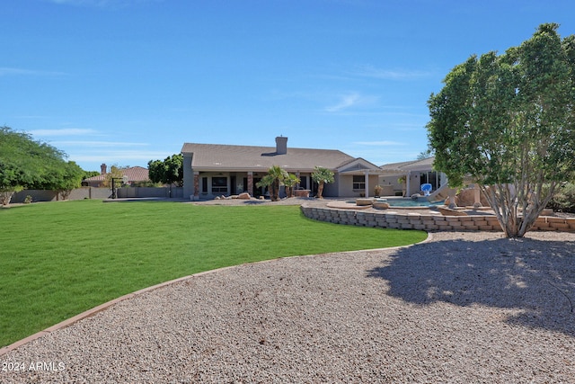 back of house with a yard and a patio area