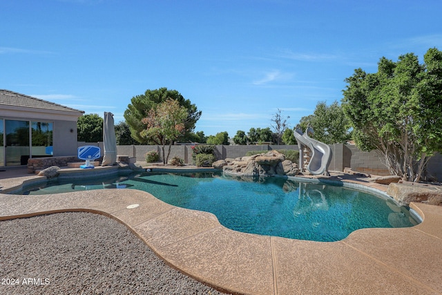 view of swimming pool featuring a patio and a water slide