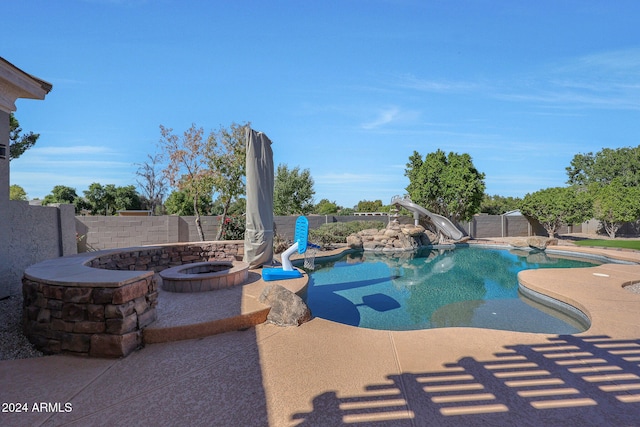 view of pool with a patio and a water slide