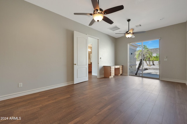 empty room with ceiling fan and dark hardwood / wood-style flooring