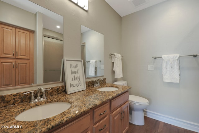 bathroom featuring toilet, hardwood / wood-style floors, and vanity