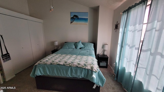 bedroom with vaulted ceiling, a closet, and carpet flooring